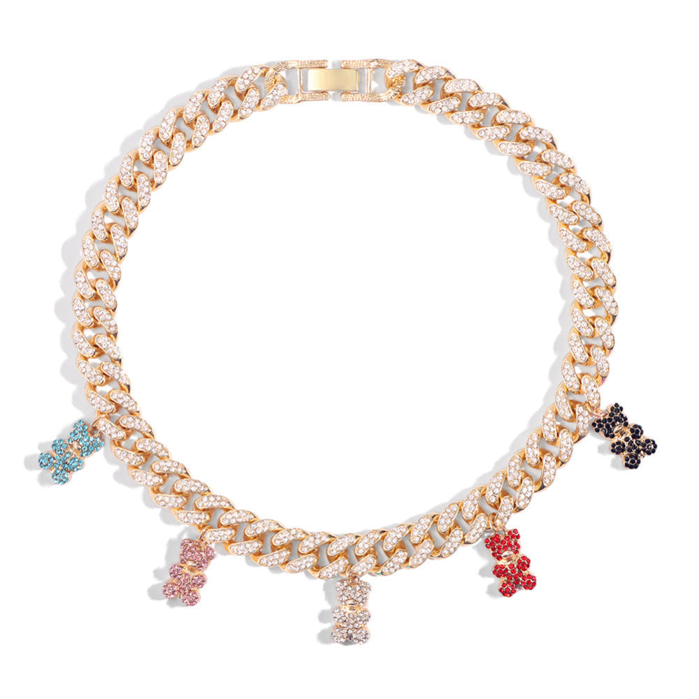 Luxury gold Cuban link choker necklace fully iced with sparkling cubic zirconia stones, featuring colorful teddy bear charms in light blue, pink, red, black, and clear. Bold and glamorous statement jewelry piece.