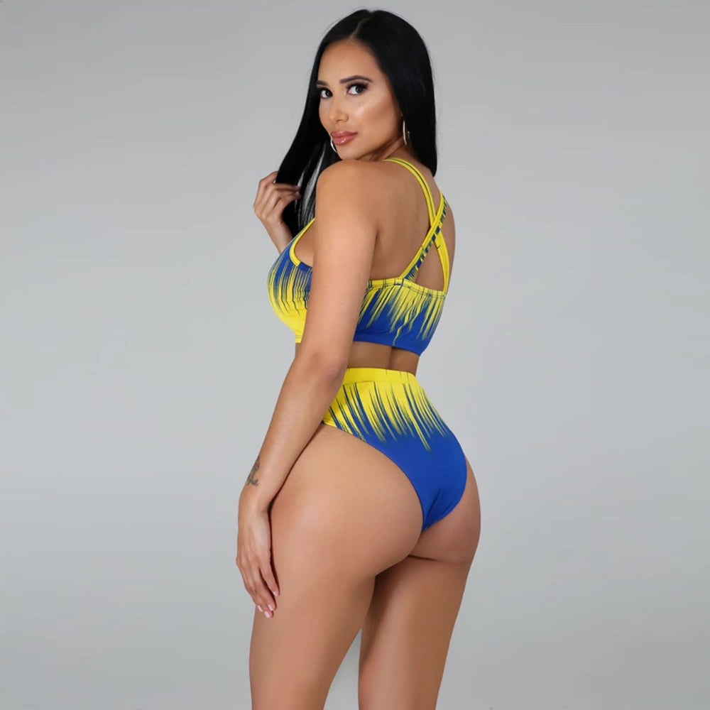 Woman wearing a blue and yellow bikini set on a gray background