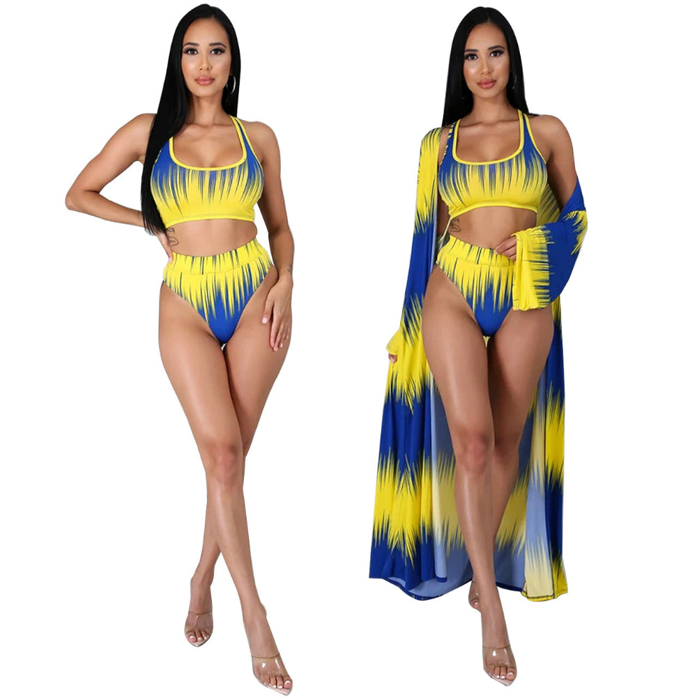 Woman wearing a yellow and blue swimsuit with a matching cover-up on a white background