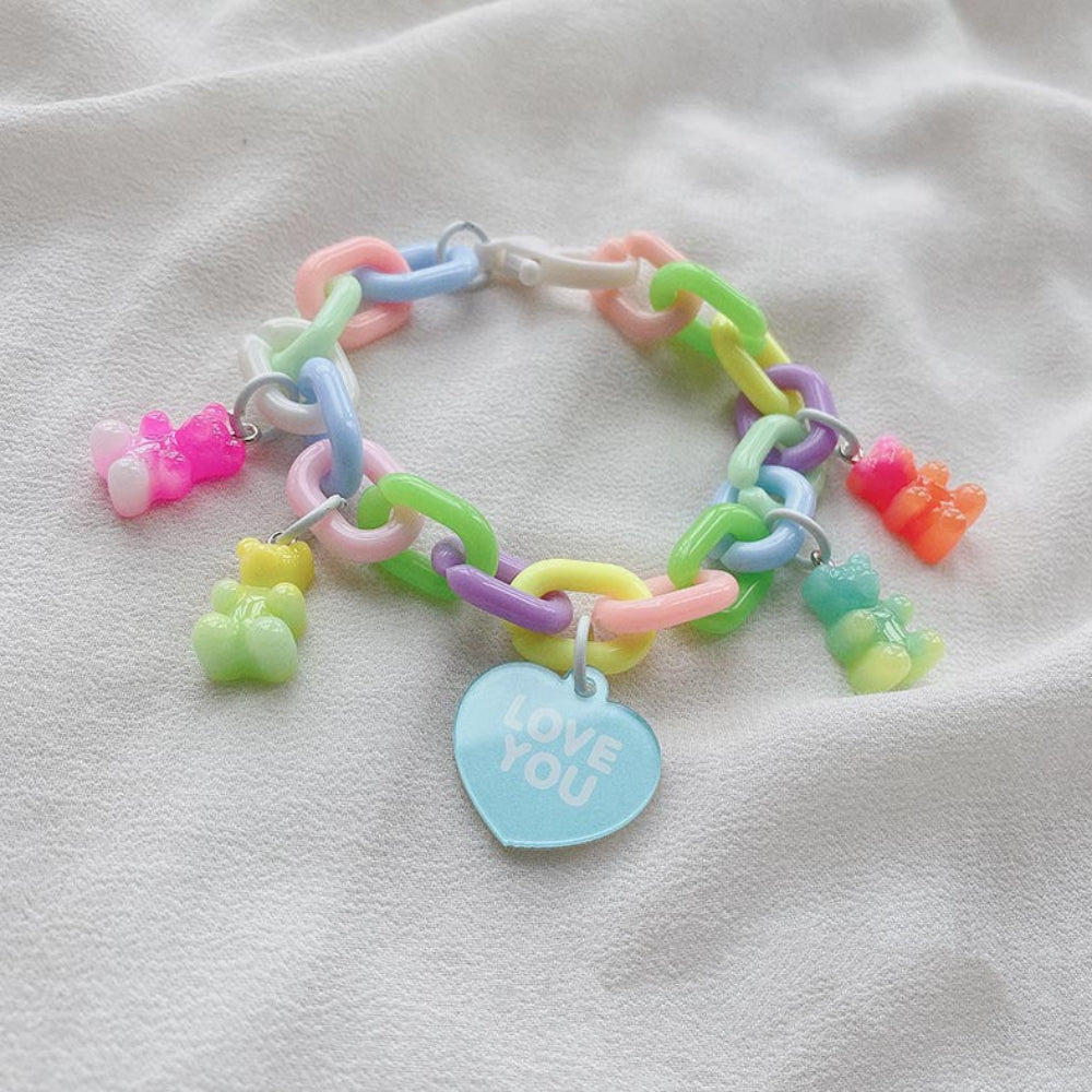 Pastel rainbow chunky chain bracelet with multicolored gummy bear charms and a pink heart charm that says "LOVE YOU"