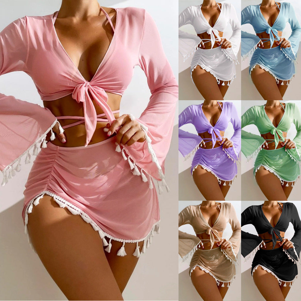 Long sleeve tie-front crop top and ruched tassel mini skirt matching beach set in multiple colors.