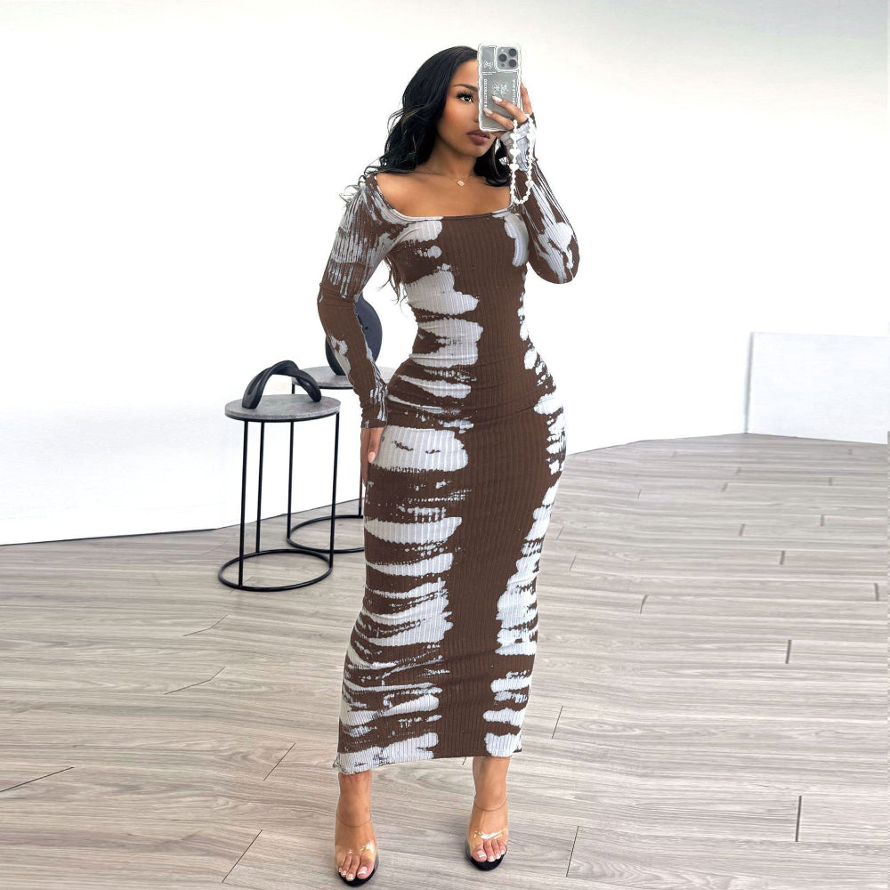 Woman taking mirror selfie in brown and white tie-dye ribbed long-sleeve bodycon midi dress with off-shoulder neckline and clear heels.