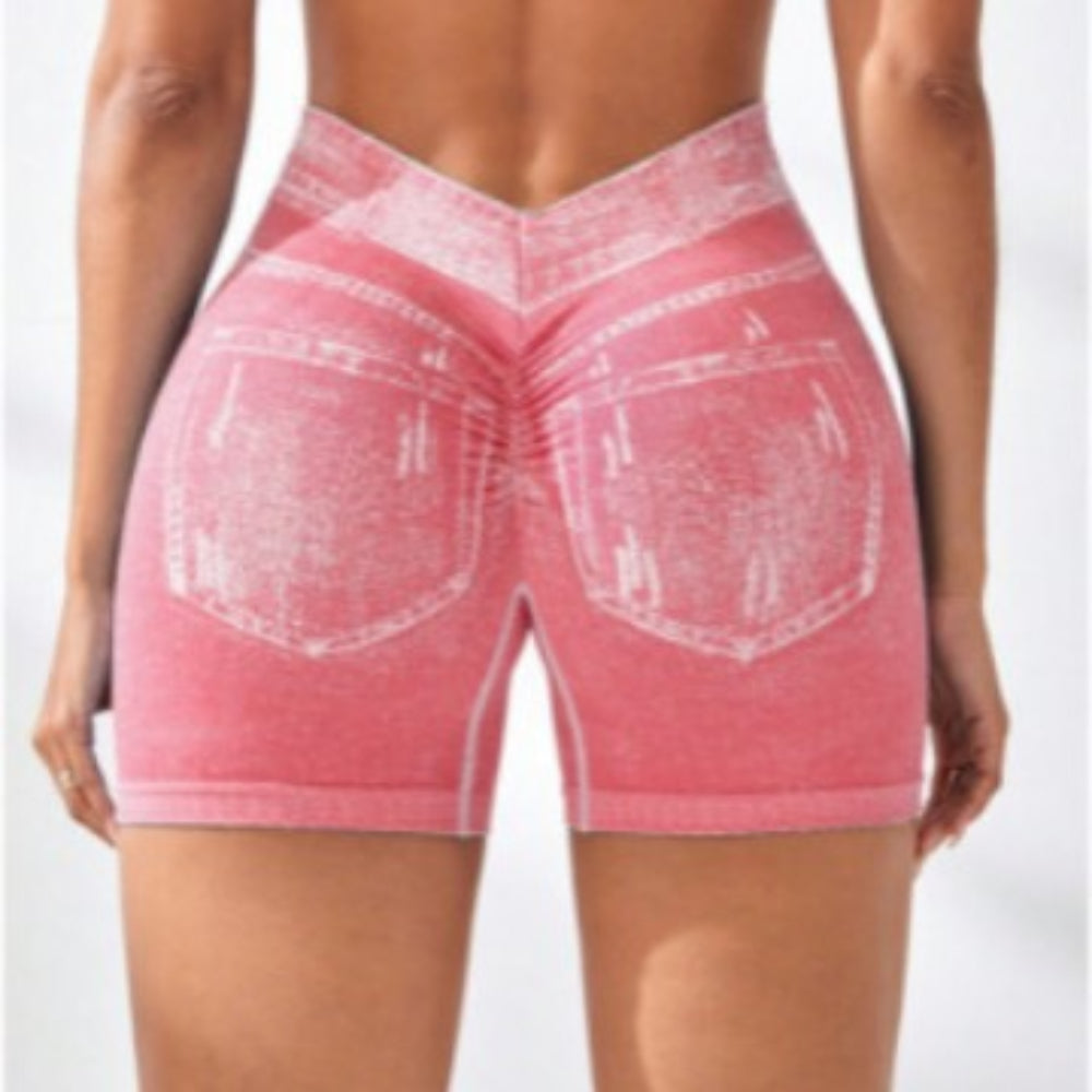 Woman modeling pink denim-style high-waisted stretch shorts with white contrast stitching and back pockets, shown from the back view against a clean white studio background.