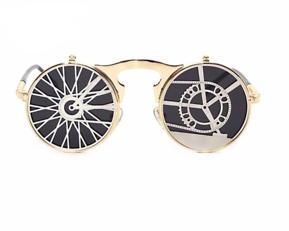 Gold flip-up steampunk sunglasses with mismatched clock-and-gear covers over dark lenses, front product photo on a white background.