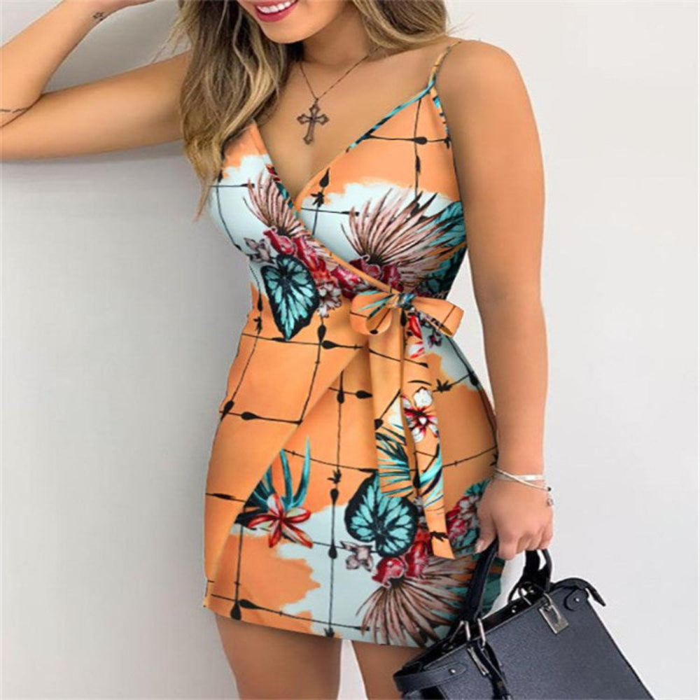 Orange tropical floral print mini dress on model – trendy grid palm leaf wrap dress with bow detail, studio white background.
