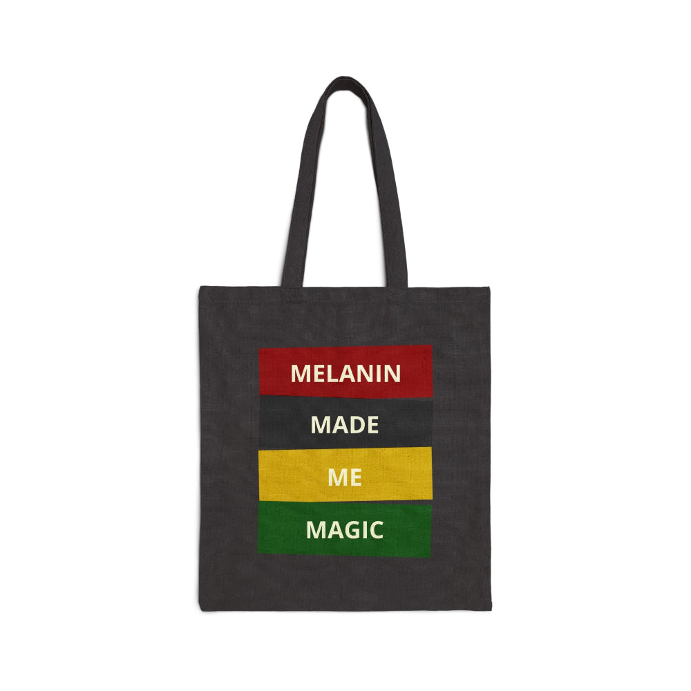 Black canvas tote bag with "MELANIN MADE ME MAGIC" empowering graphic.