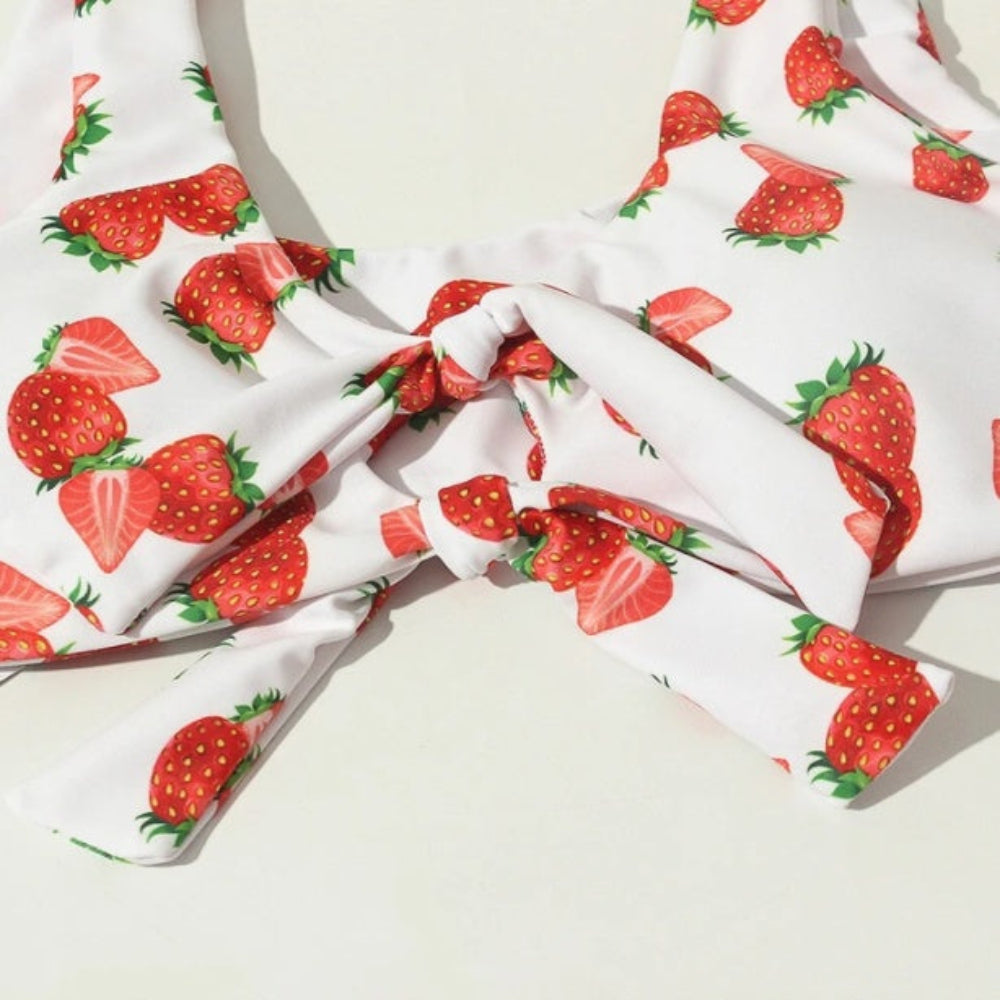 White fabric with red strawberry pattern on a light background