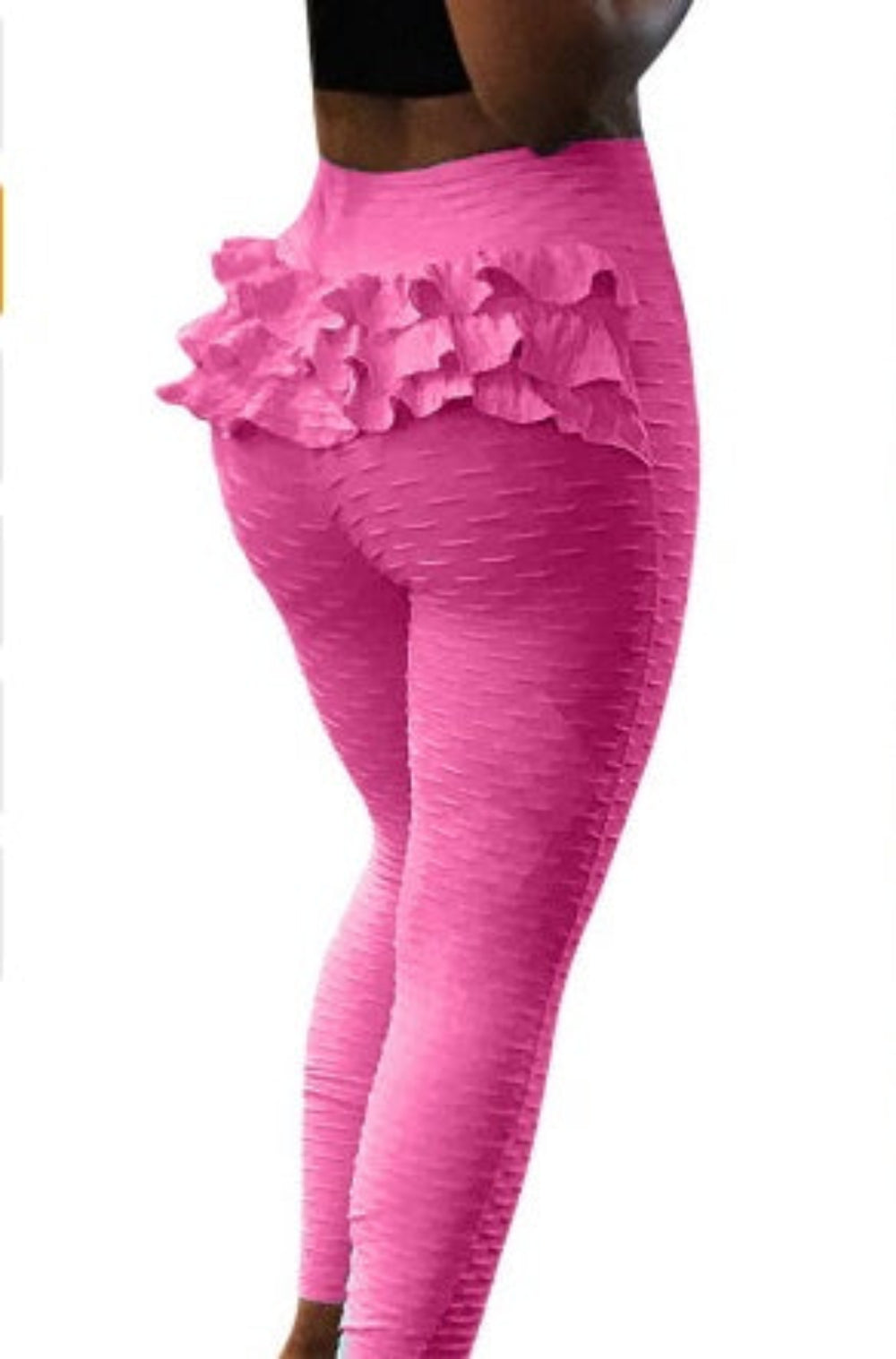 Model wearing vibrant pink stretch high-waisted leggings featuring a textured crinkle fabric and eye-catching tiered ruffle layers around the hips and waist. Rear side view highlighting the flattering fit and decorative ruffle design on a plain white background.