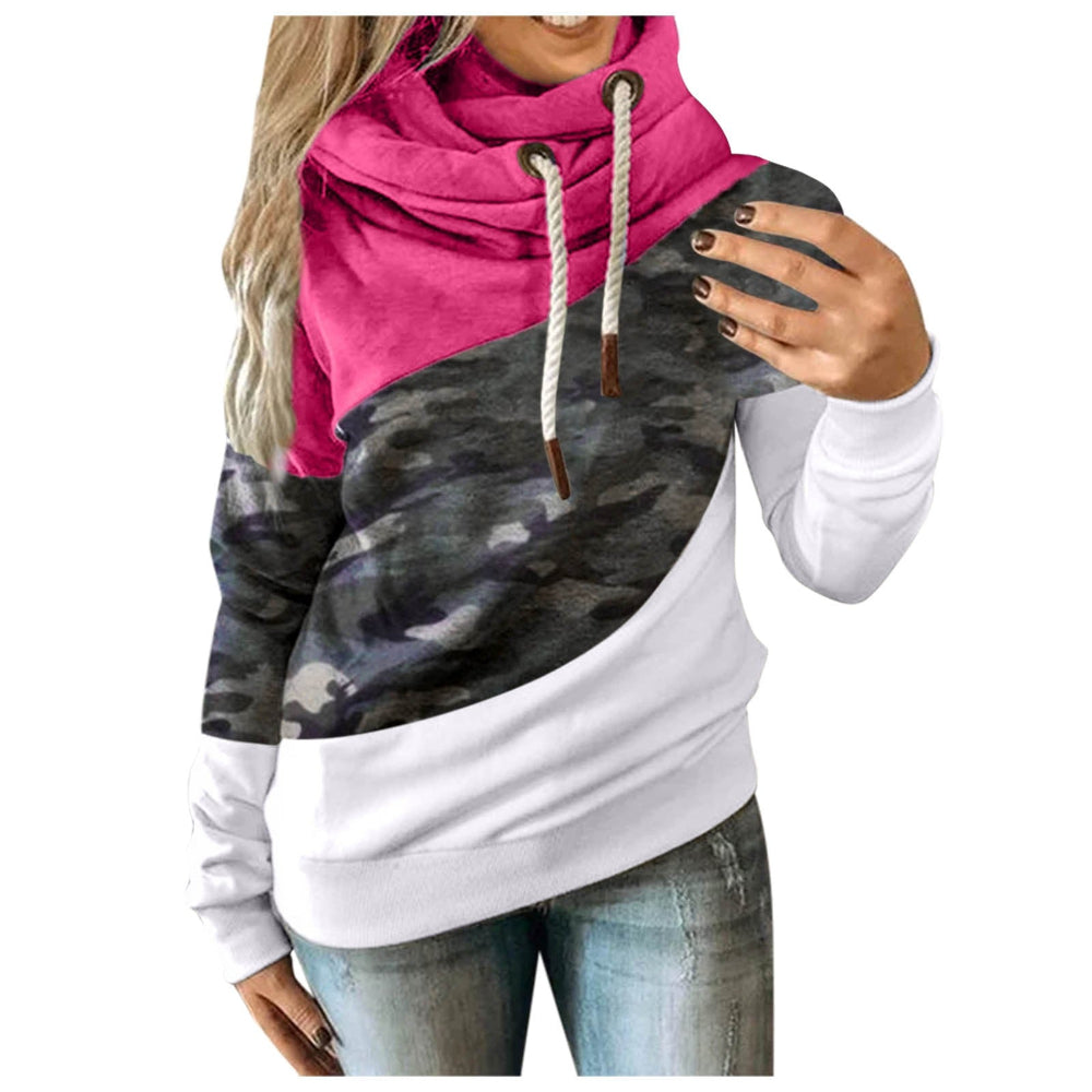 Woman wearing a color block cowl-neck hoodie in pink, camouflage, and white.