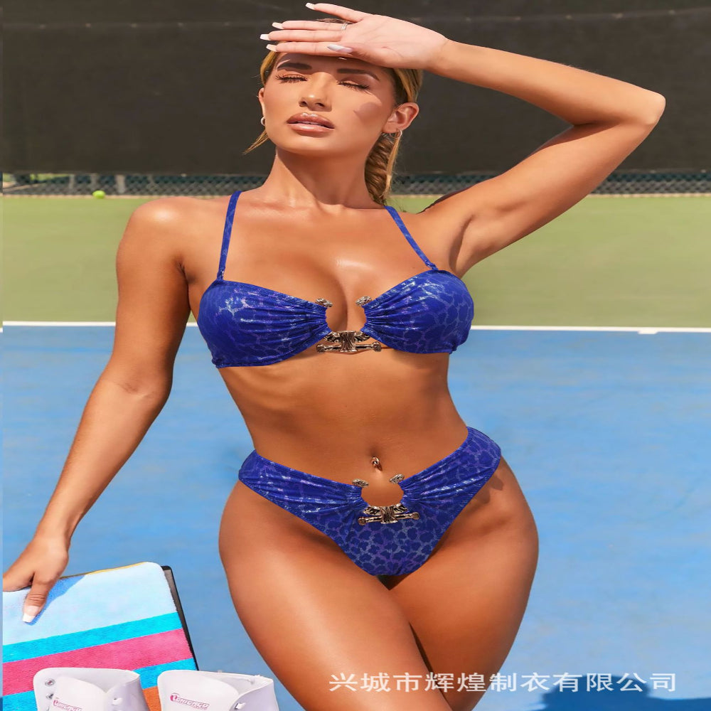 Woman in a blue bikini standing on a tennis court