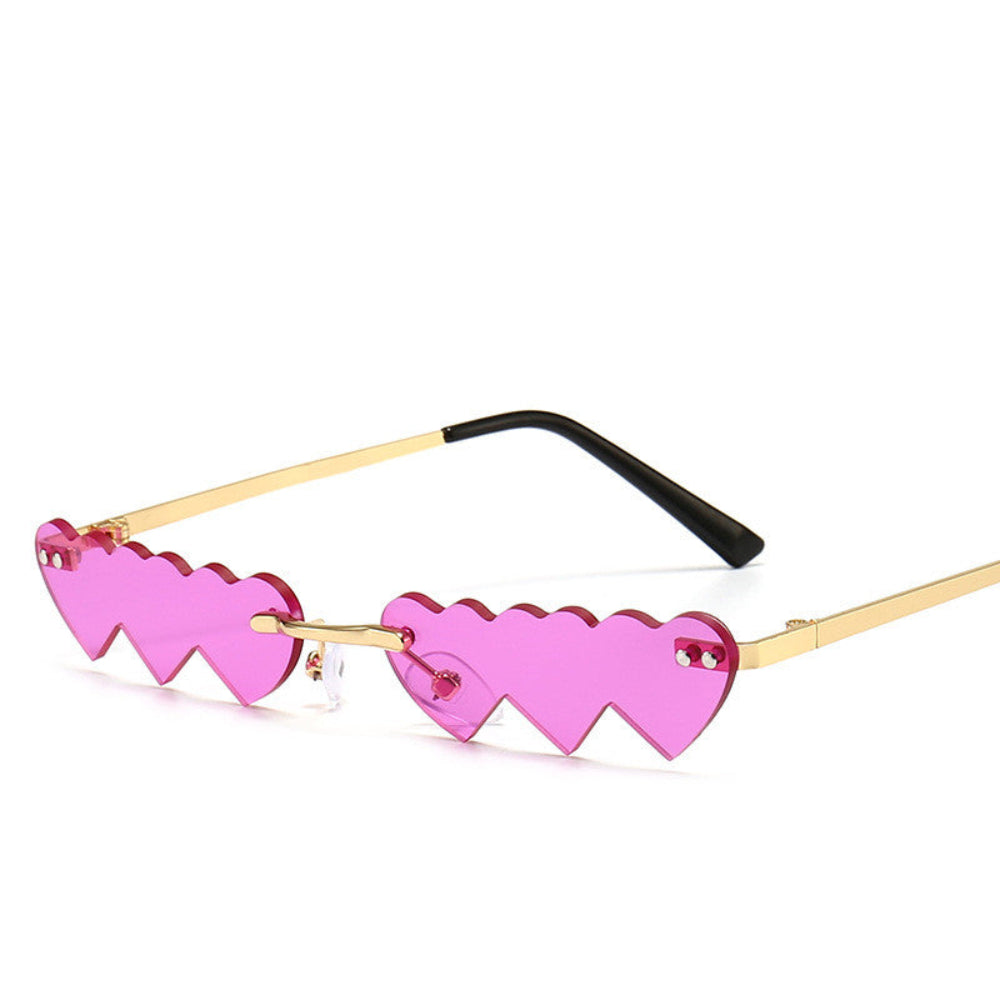 Rimless hot-pink heart-shaped sunglasses with gold temples, product photo on a white background.