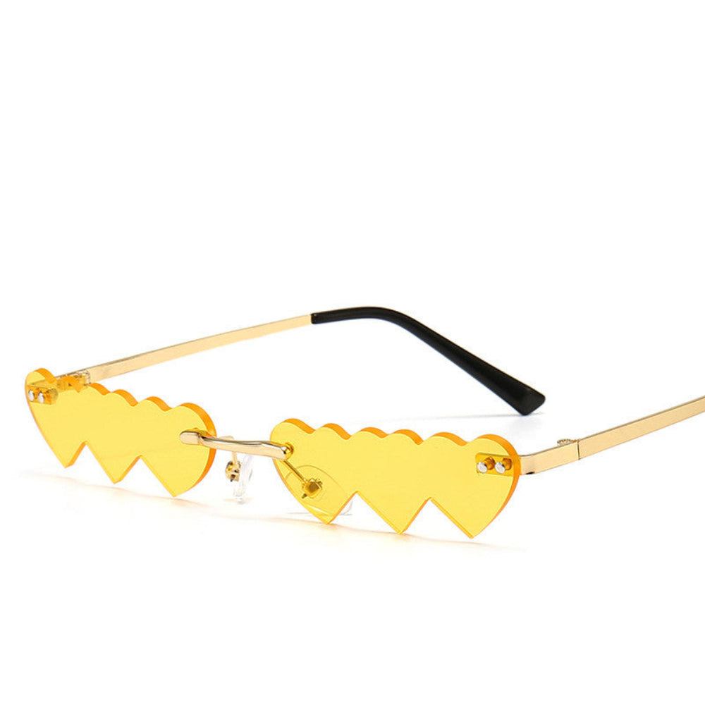 Rimless yellow heart-shaped sunglasses with gold temples, product photo on a white background.