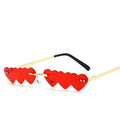 Rimless red heart-shaped sunglasses with gold temples, product photo on a white background.