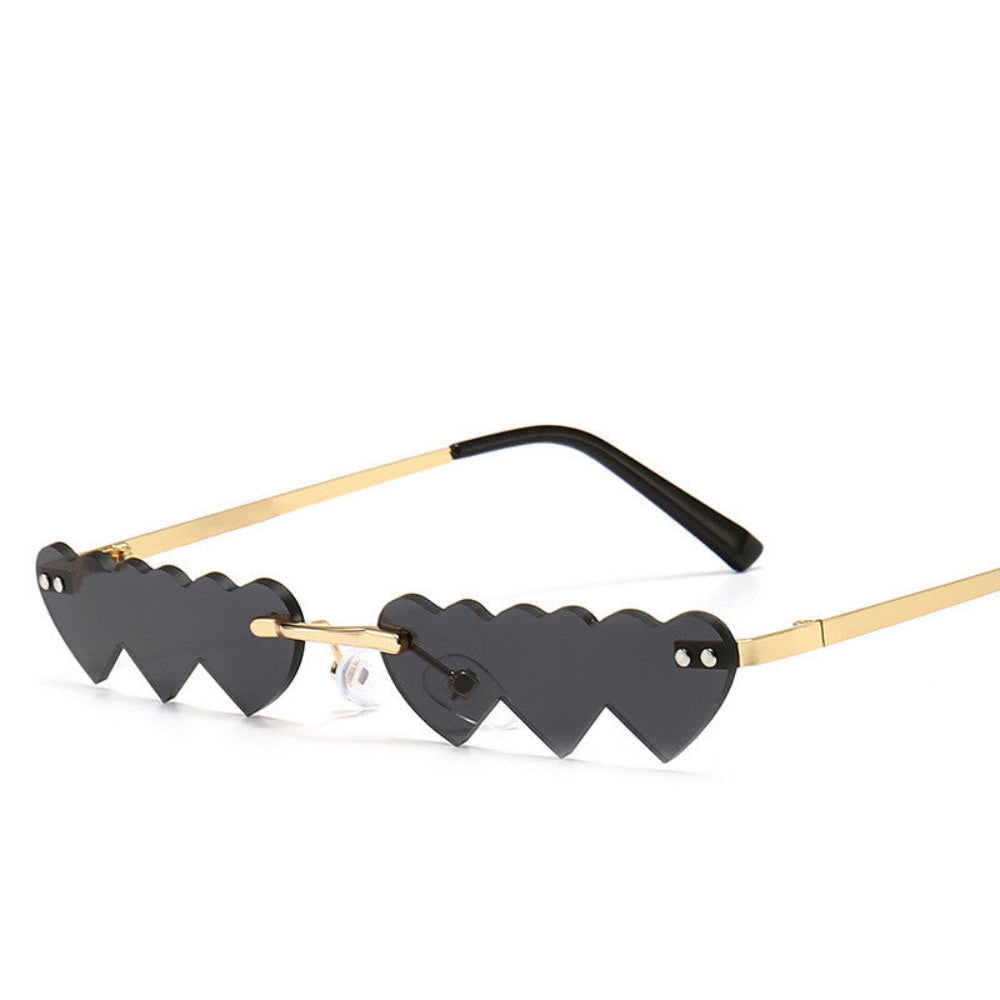 Rimless black heart-shaped sunglasses with gold temples, product photo on a white background.