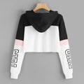 Black, white and pink colorblock cropped hoodie with "GIRL" graphic print on the sleeves, shown from the back on a wooden hanger.