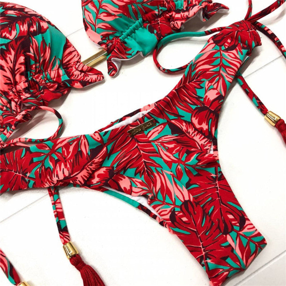 Red and green floral bikini set on a white surface
