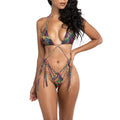 Woman wearing a colorful tropical print bikini on a white background