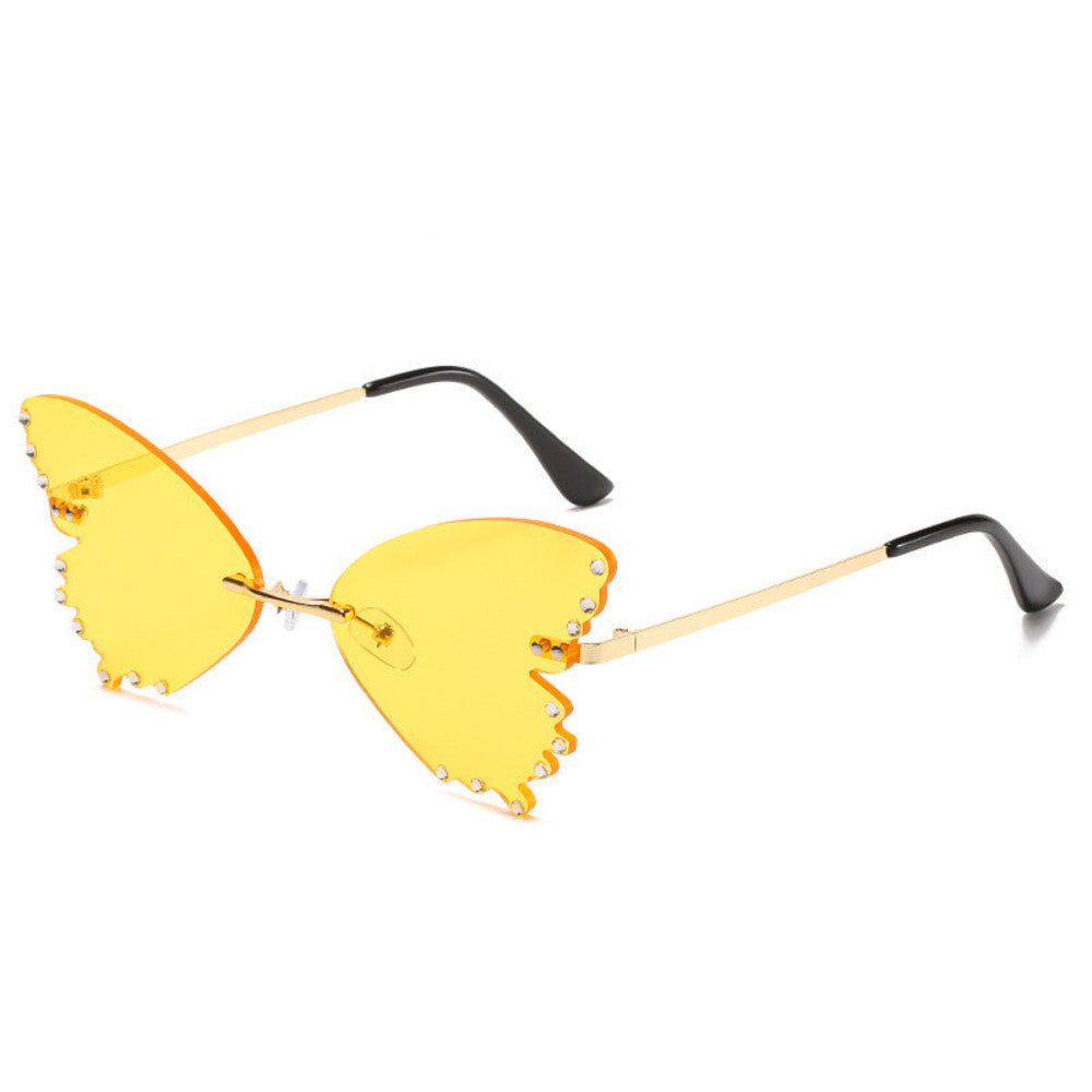 Rimless butterfly sunglasses with yellow lenses, rhinestone edges, and gold temples, product photo on a white background.