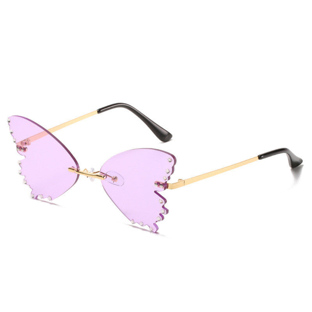 Rimless butterfly sunglasses with purple lenses, rhinestone edges, and gold temples, product photo on a white background.
