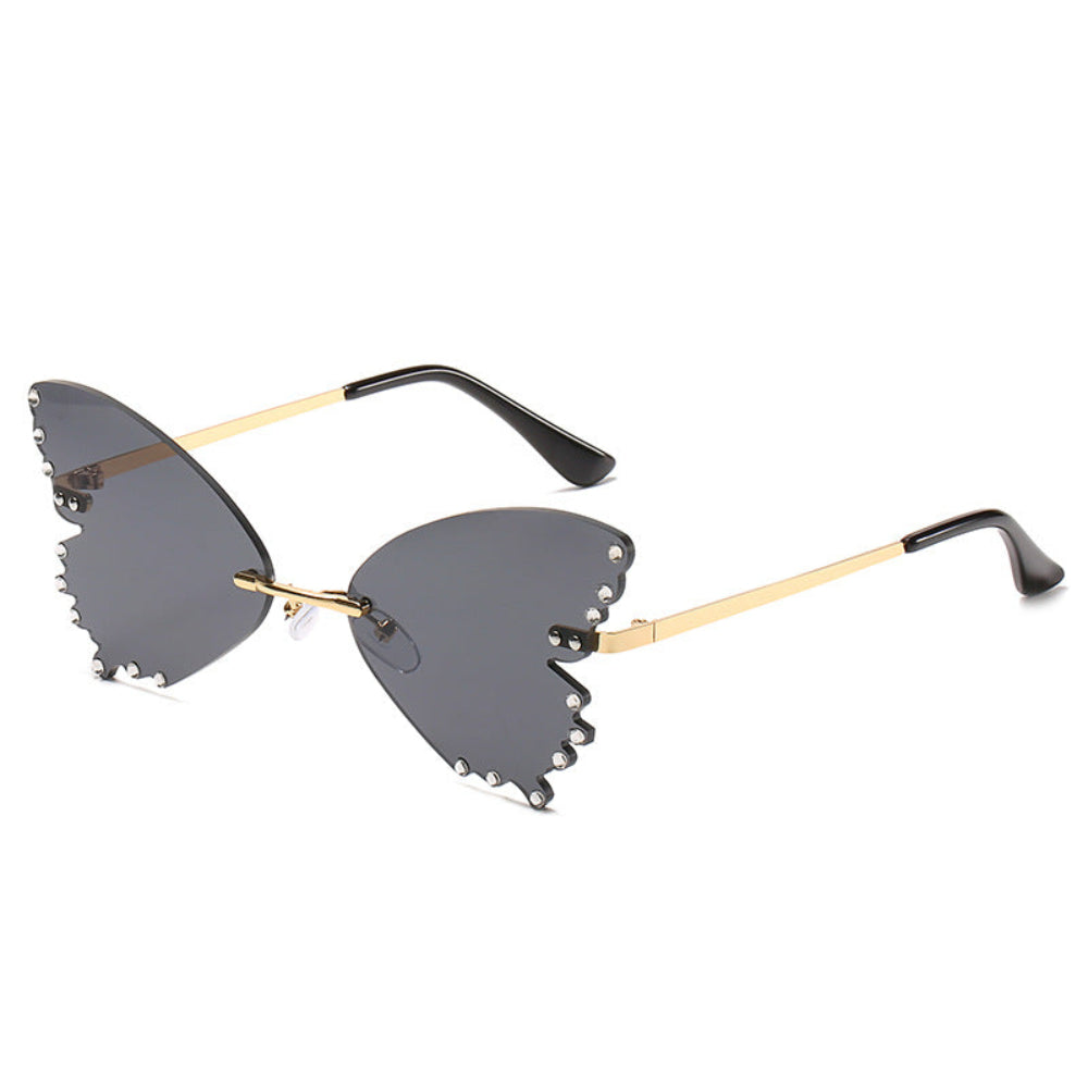 Rimless butterfly sunglasses with dark gray lenses, rhinestone edges, and gold temples, product photo on a white background.