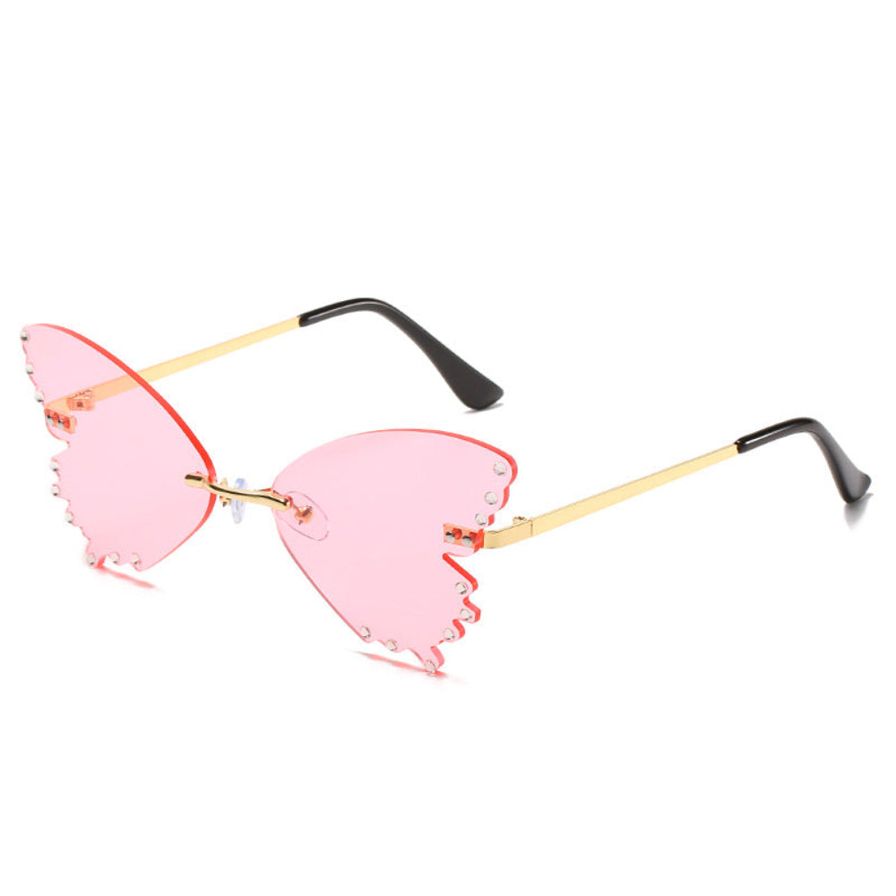 Rimless butterfly sunglasses with pink lenses, rhinestone edges, and gold temples, product photo on a white background.