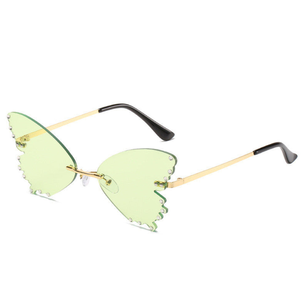 Rimless butterfly sunglasses with light green lenses, rhinestone edges, and gold temples, product photo on a white background.