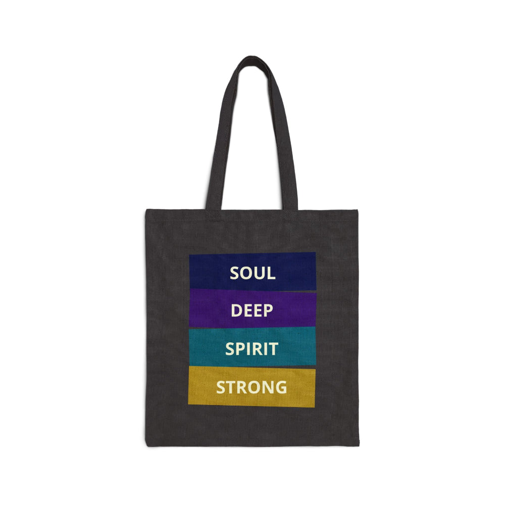 Black canvas tote bag with "SOUL DEEP SPIRIT STRONG" motivational quote in colorful stacked blocks (navy, purple, teal, gold) against white background.