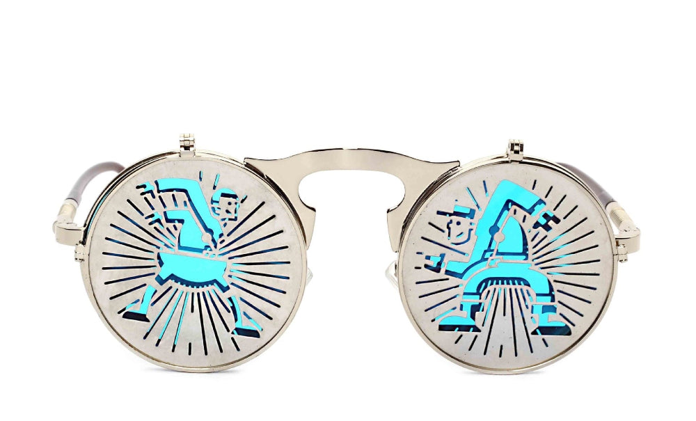 Silver flip-up steampunk sunglasses with cutout rider-and-figure covers over turquoise lenses, front product photo on a white background.