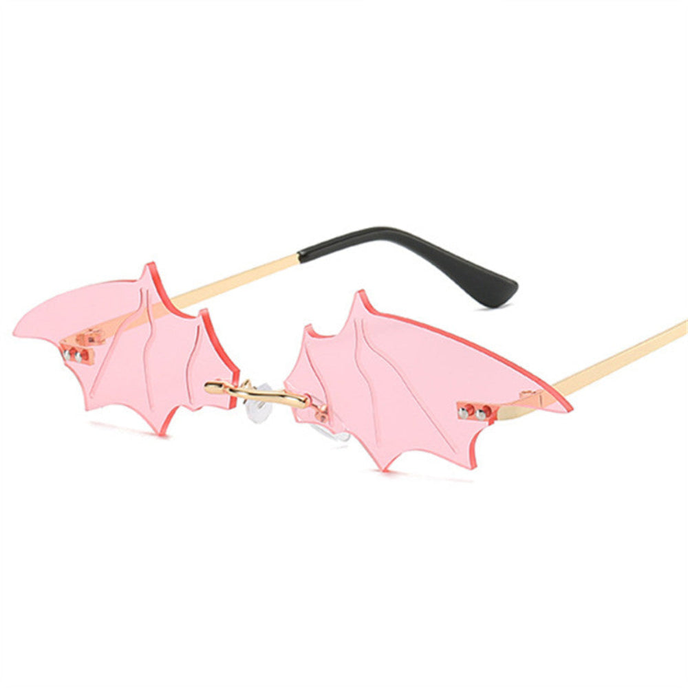 Rimless pink bat-wing sunglasses with gold temples, product photo on a white background.