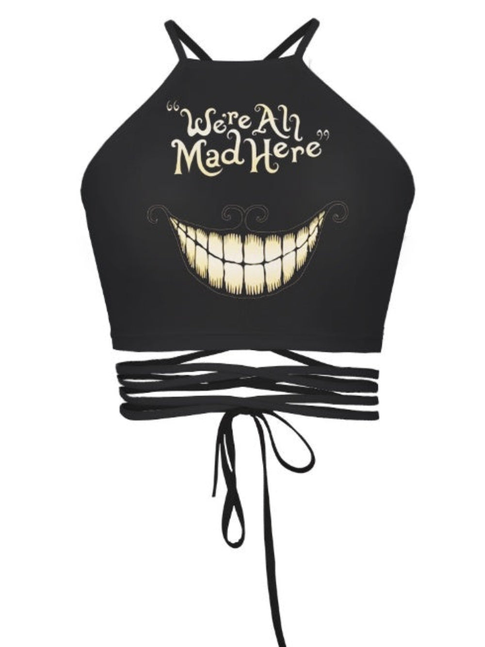 Black halter crop top with "We're All Mad Here" quote and Cheshire Cat grin graphic print, featuring multi-strap tie-back detail, shown flat lay on white background.