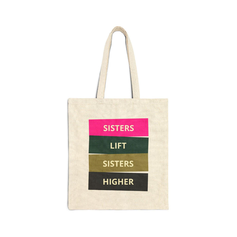 Natural canvas tote bag with "SISTERS LIFT SISTERS HIGHER" graphic in colorful blocks.
