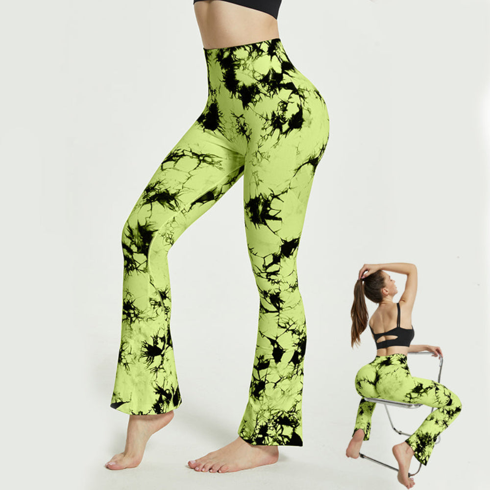 Woman modeling lime green and black tie-dye high-waisted flared leggings, shown from a rear three-quarter view while standing barefoot, with an inset image of the same outfit while seated on a chair against a clean white studio background.