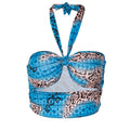 Blue leopard print halter crop top with twist front detail, halter neck tie, and patterned bandeau band. Features a mix of turquoise blue, black leopard spots, and geometric designs.
