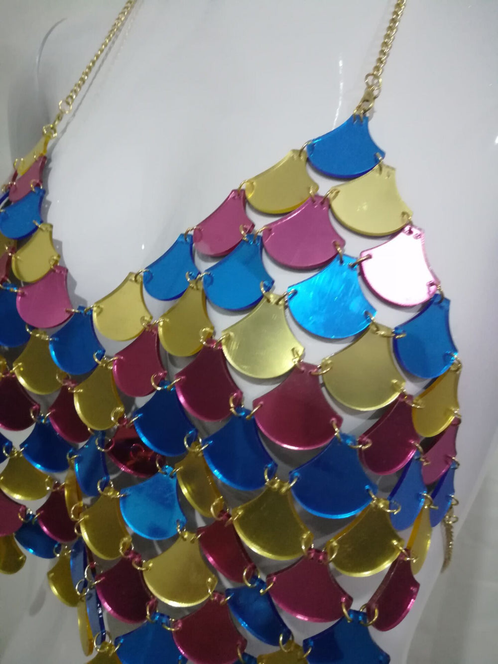 Multicolor scale sequin halter crop top in pink, blue, yellow and gold, close-up detail view.