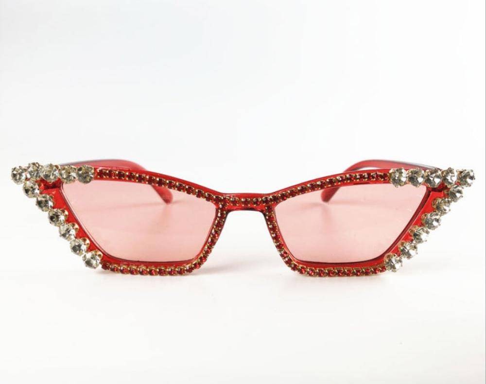 Red cat-eye sunglasses with pink lenses and crystal rhinestone trim, product photo on a white background.