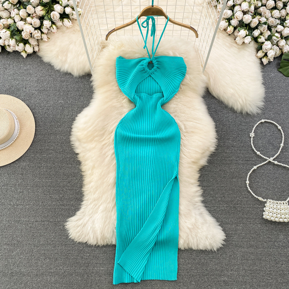 Turquoise ribbed knit halter maxi dress with front keyhole cutout on wooden hanger.