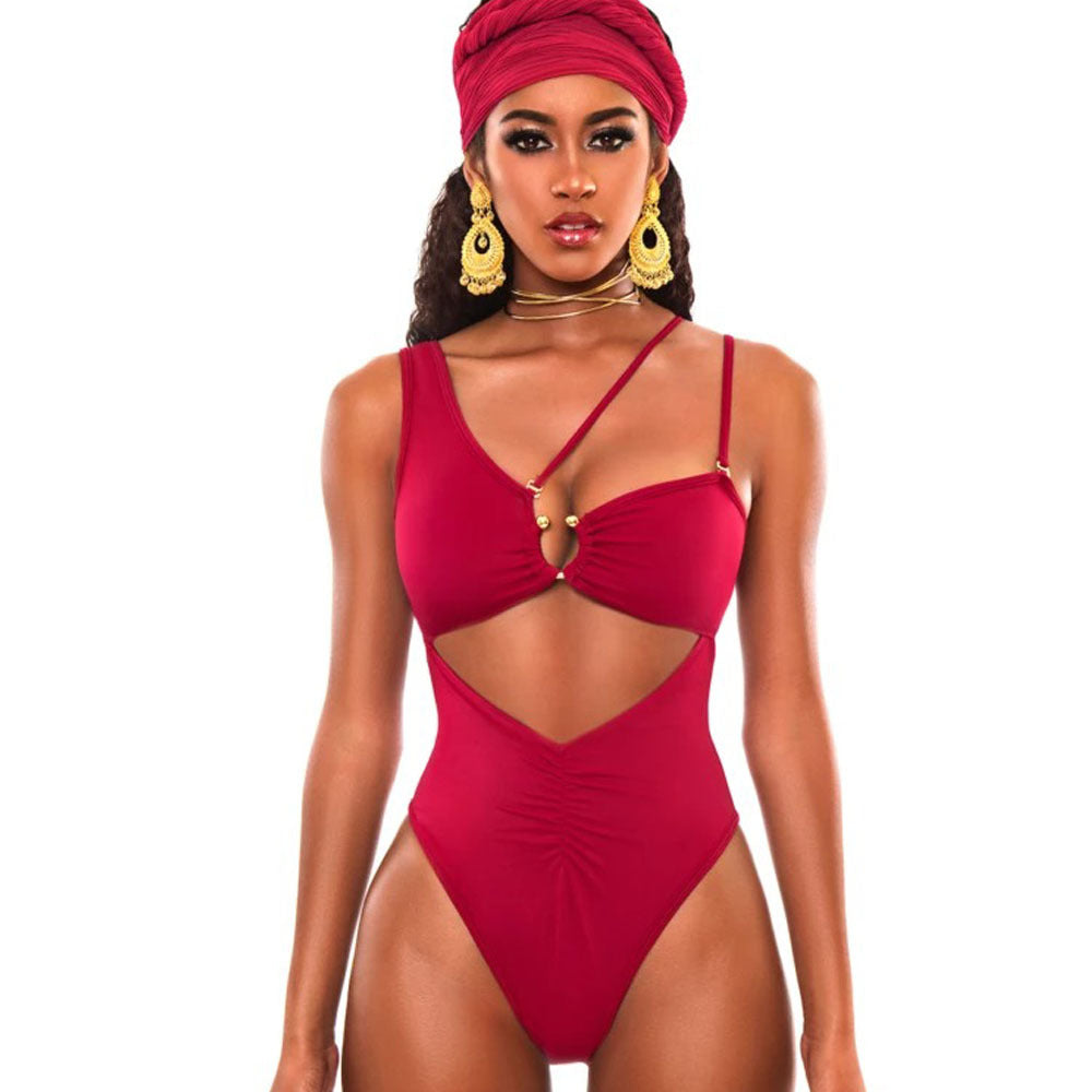 Woman wearing a red swimsuit with cut-out design on a white background