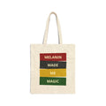 Natural canvas tote bag with "MELANIN MADE ME MAGIC" graphic in red, black, yellow, and green blocks.