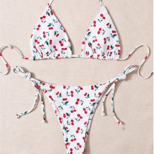 Cherry print bikini set with triangle halter top and tie-side bikini bottom.