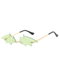 Rimless light-green bat-wing sunglasses with gold temples, product photo on a white background.