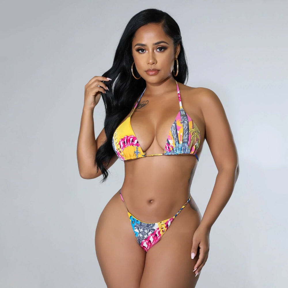 Woman wearing a colorful bikini against a gray background