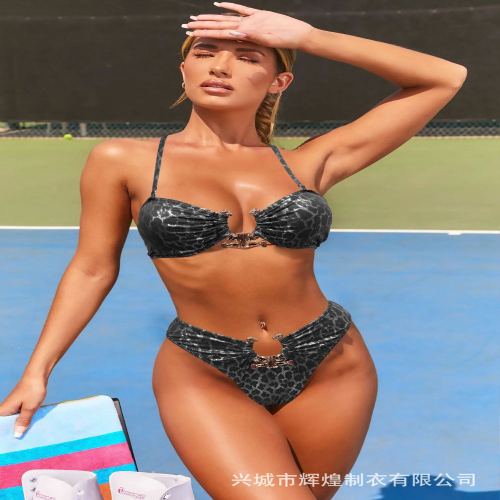 Woman in a black bikini with leopard print pattern on a tennis court