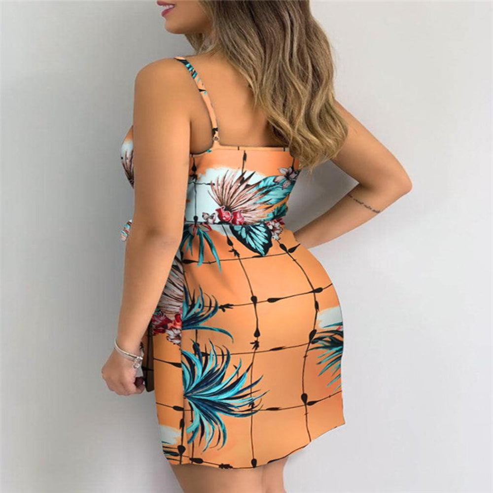 Peach tropical floral print mini dress on model (back view) – trendy orange grid palm leaf bodycon dress with bow detail, studio fashion shot.