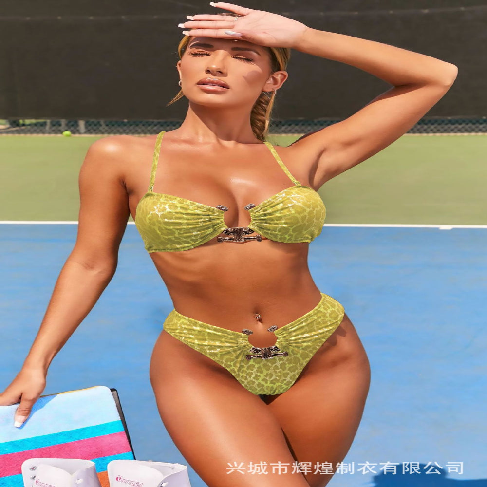 Woman in a green bikini standing on a tennis court