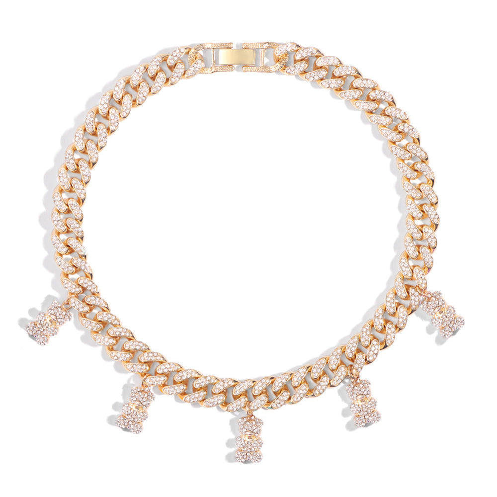 Gold Cuban link choker necklace fully iced with sparkling cubic zirconia stones, featuring multiple dangling teddy bear charms also fully paved with CZ. Bold luxury statement piece displayed on a clean white background.