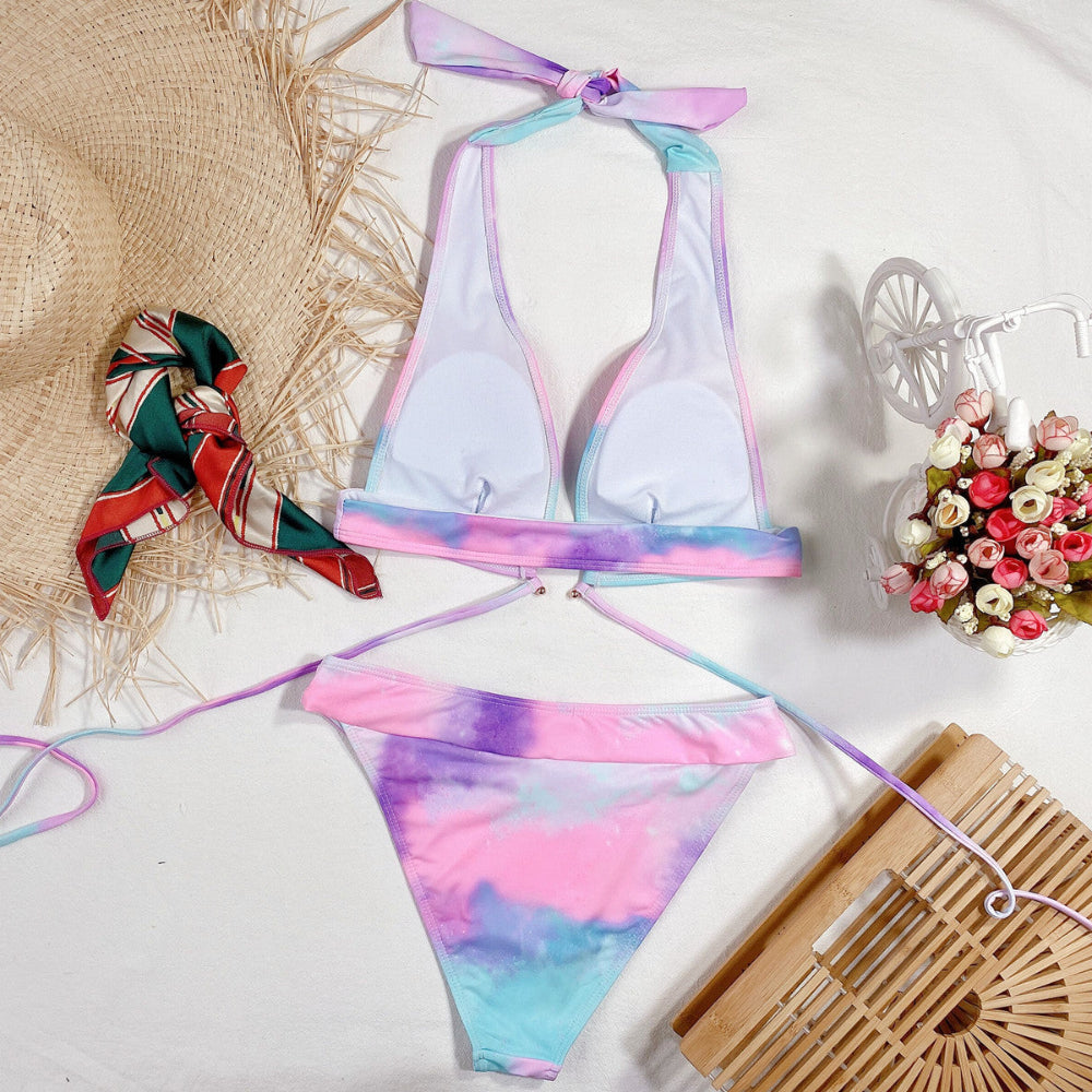 Pastel tie-dye bikini set in pink purple blue with halter triangle top and tie-side bottom flat lay