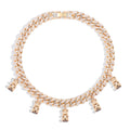 Gold Cuban link chain necklace fully iced with sparkling cubic zirconia stones, featuring multiple dangling teddy bear charms. Bold luxury choker-style statement piece displayed on a clean white background.