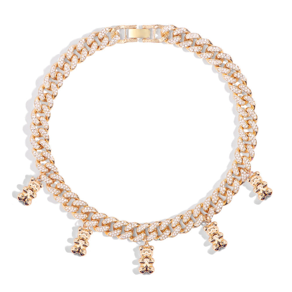 Gold Cuban link chain necklace fully iced with sparkling cubic zirconia stones, featuring multiple dangling teddy bear charms. Bold luxury choker-style statement piece displayed on a clean white background.