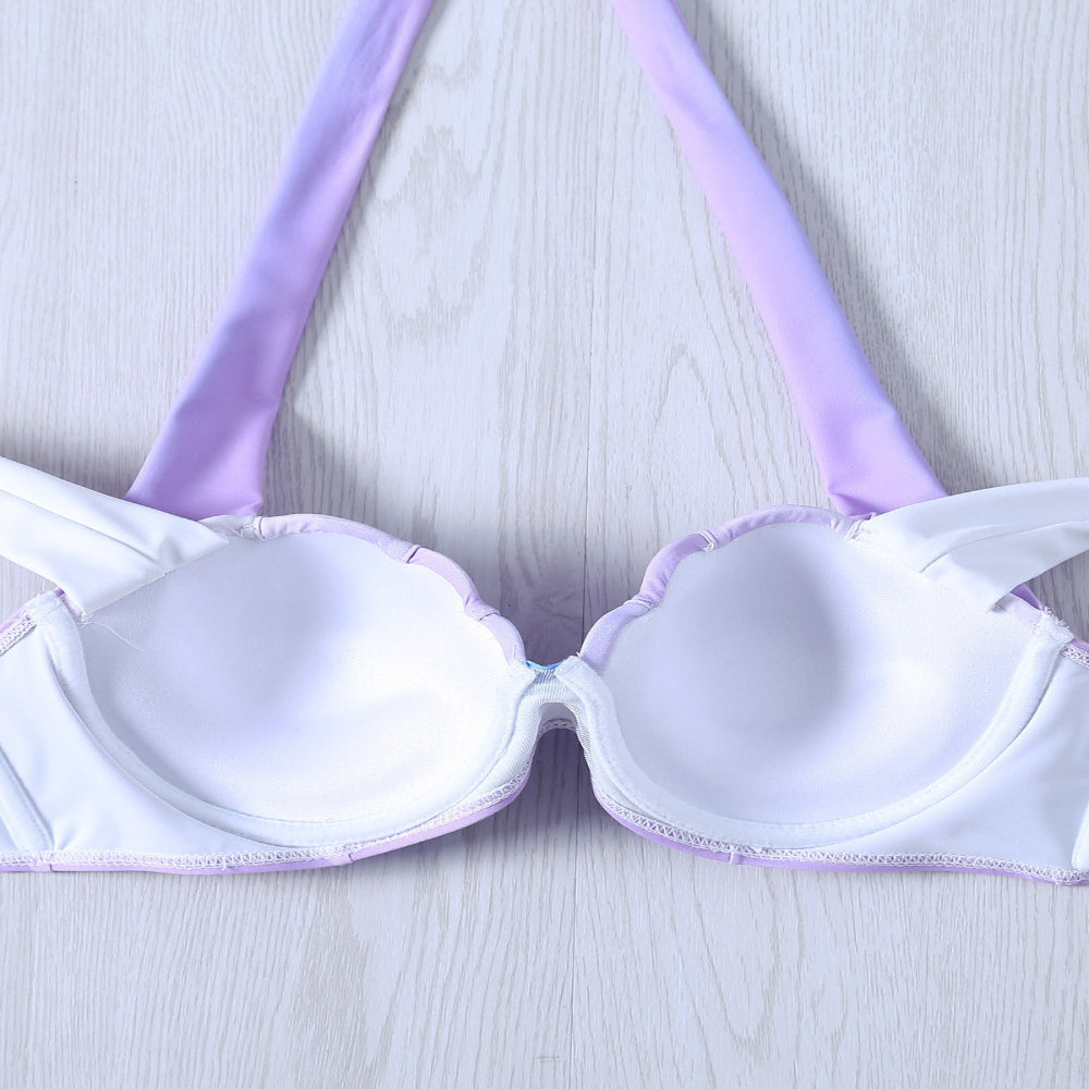 White bra with purple straps on a light gray background