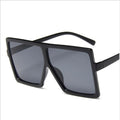 Black sunglasses with dark lenses on a white background